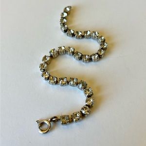 Vintage rhinestone tennis bracelet. All stones intact. Silver metal. 7” long.
